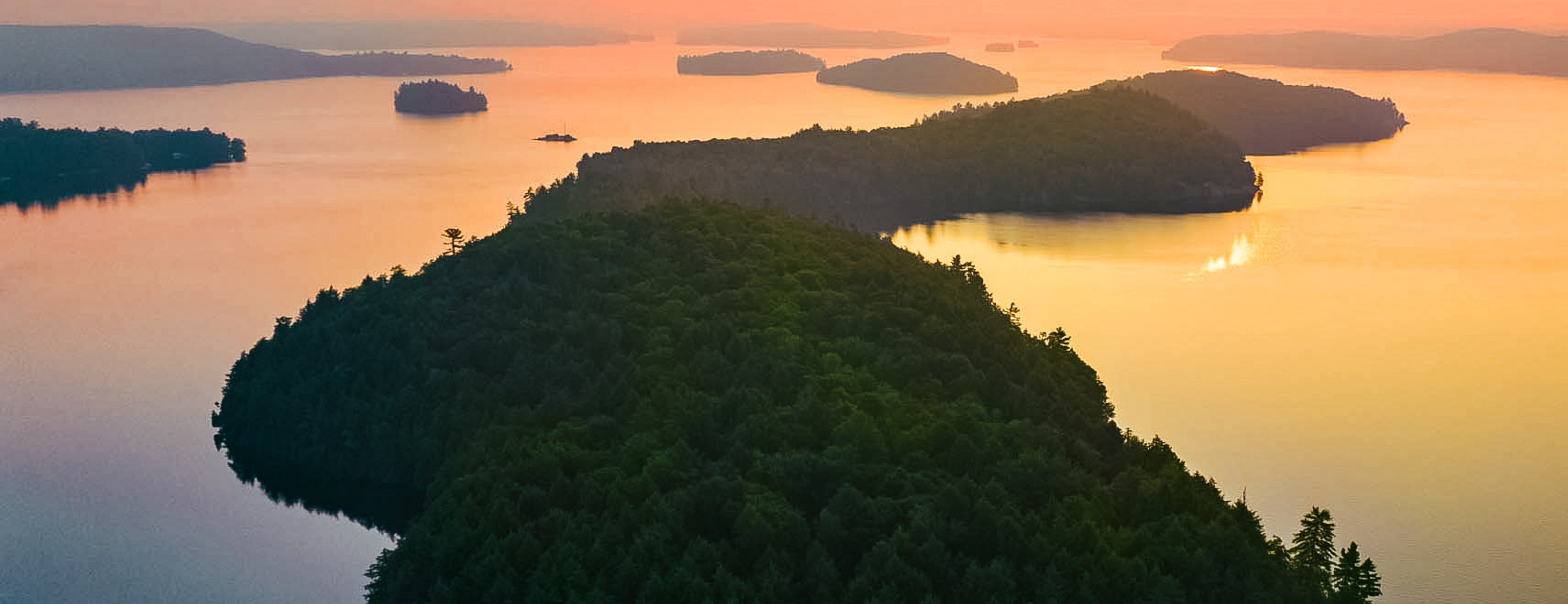 Sunset over a lake with islands and trees